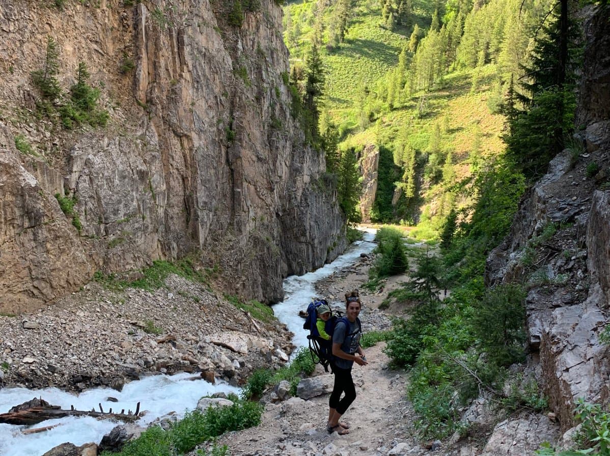 Hiker in a valley next to a stream